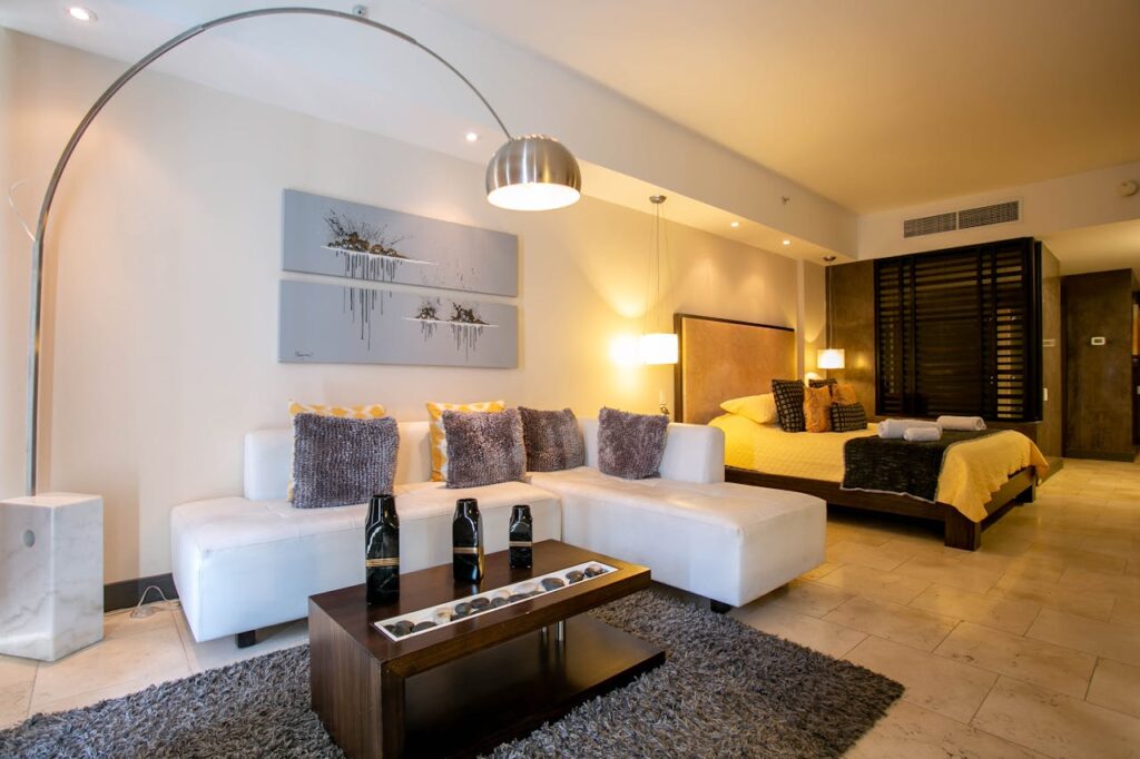 Elegant hotel suite with modern furniture and decor, showcasing luxury comfort.