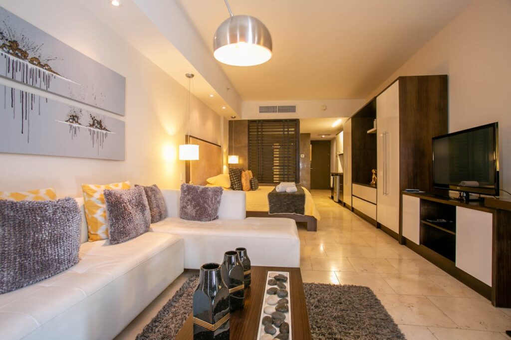 Spacious hotel room with contemporary decor and cozy furnishings.