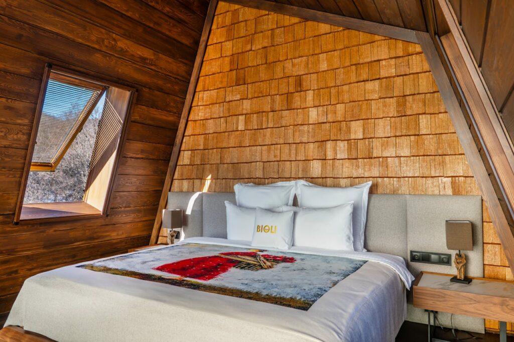 Elegant wooden bedroom interior with luxury bedding in Tbilisi, Georgia.